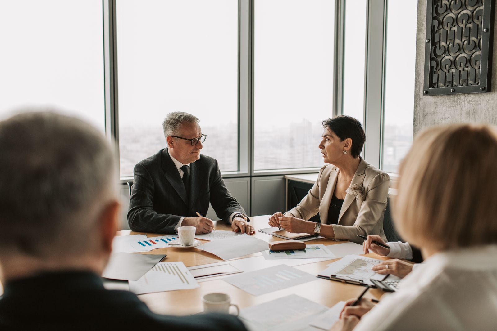Business professionals comparing options in a strategic meeting in a modern office